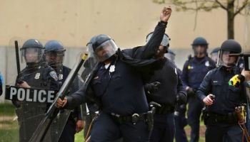 Cop Throws Rocks At Baltimore Protestors
