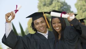 Graduates Holding Diplomas