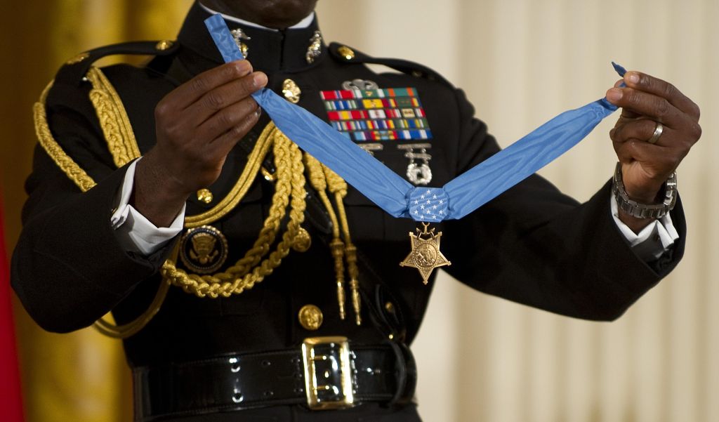 A military aide holds up the Medal of Ho