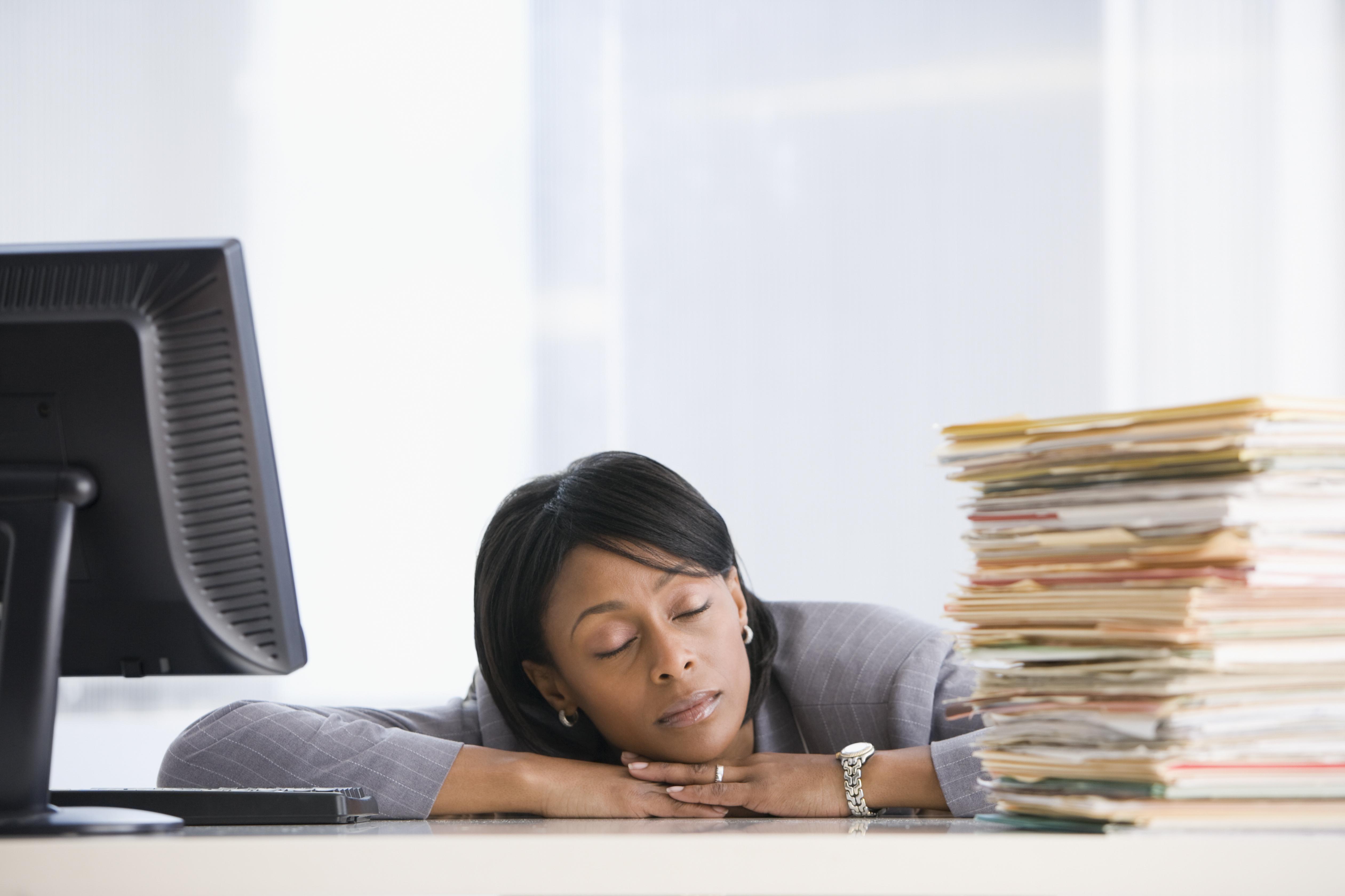 African American businesswoman sleeping at desk