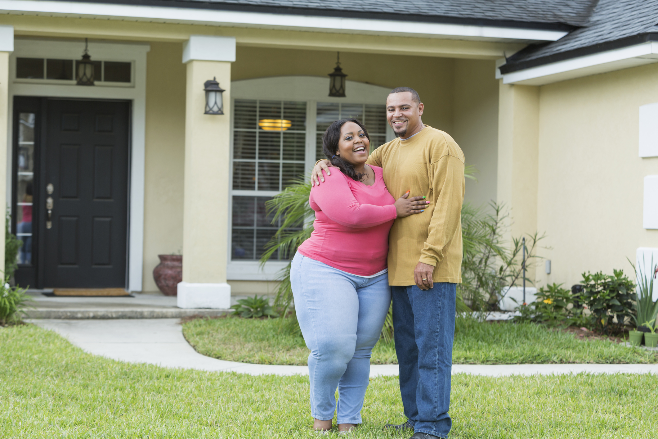 Young African American couple outside home