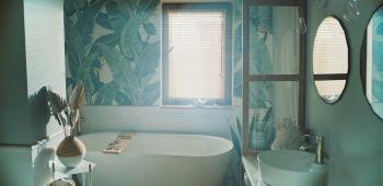 Home SPA inside bathroom. Tropical leaves pattern on the wall